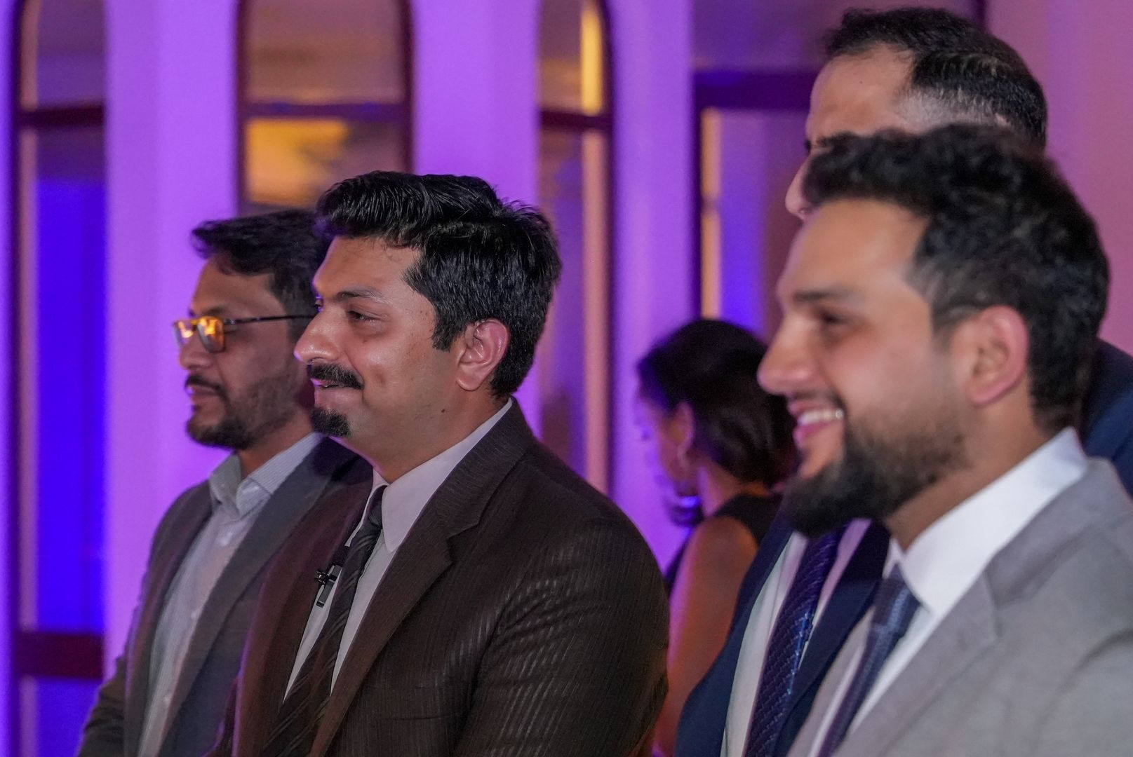 Group of professionals smiling at a business event, promoting job opportunities with Solution Founder